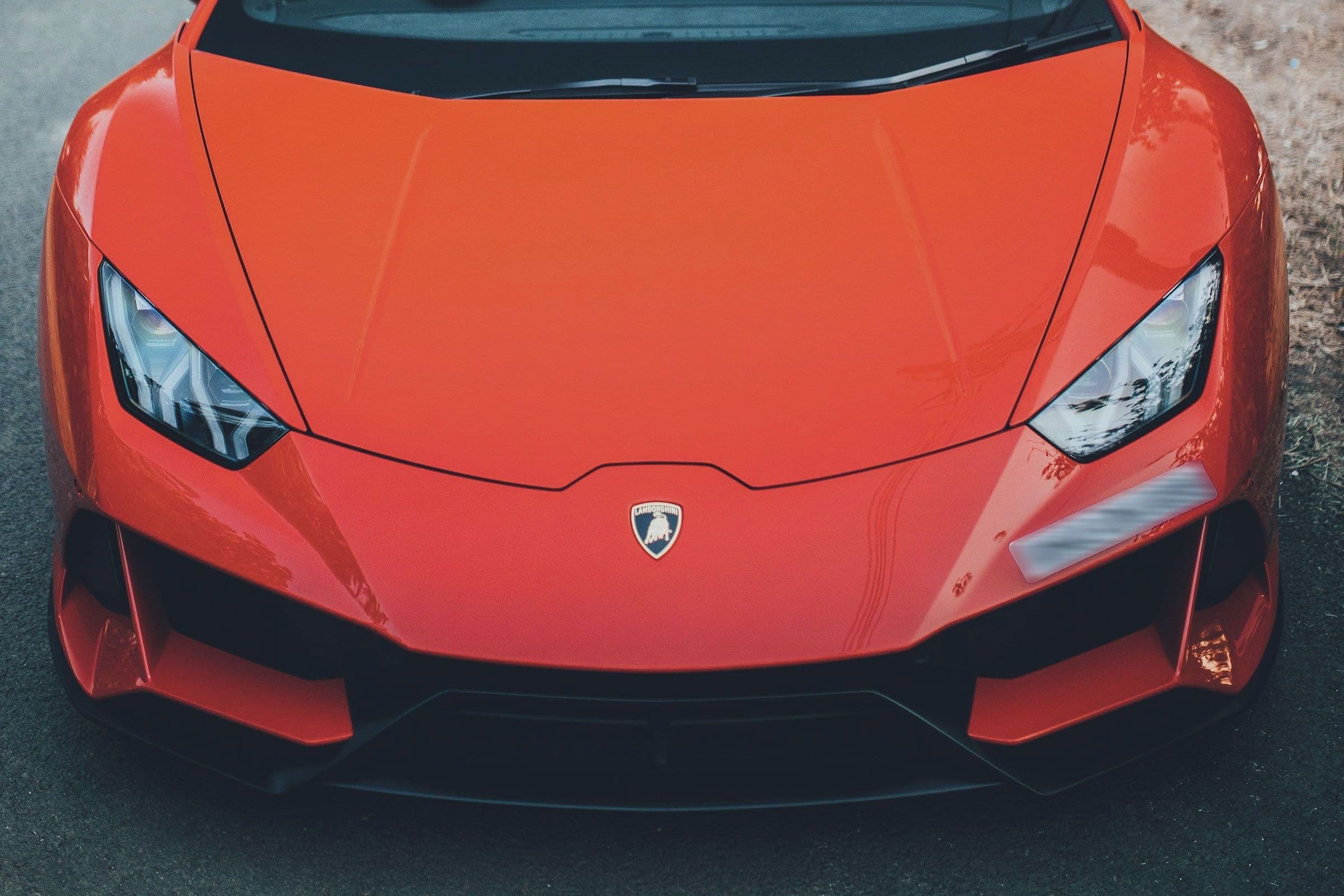 A red Lamborghini Huracán EVO head-on, seen from above the bonnet.